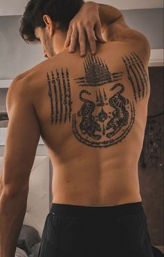 a man with a tattoo on his back