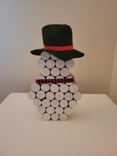 a man made out of wine corks wearing a hat