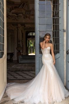 a woman in a wedding dress posing for the camera