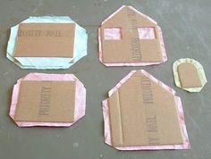 four pieces of cardboard with small houses on them