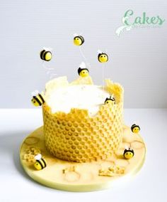 the cake is decorated with bees and icing