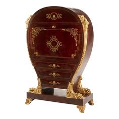 an ornate wooden cabinet with gold trimmings on the top and bottom, in red velvet