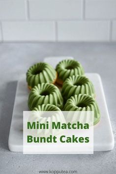 mini matcha bundt cakes on a white plate with green icing and the words, mini matcha bundt cakes