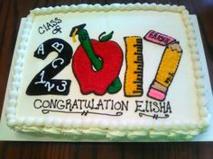 a cake decorated with an apple, ruler and pencils for a class graduation celebration