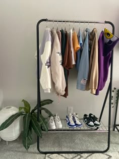 there is a rack with clothes and shoes on it