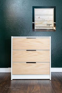 a white dresser sitting in front of a green wall