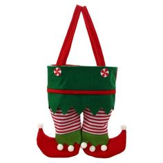 a green and red christmas stocking bag with candy canes on the bottom, hanging from it's side