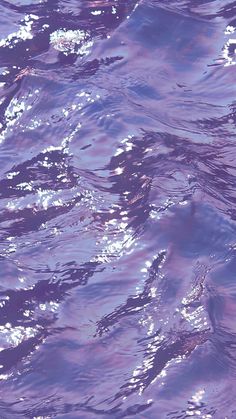 the water is very blue and purple with some white bubbles on it's surface