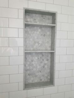 a bathroom with white subway tile and hexagonal tiles on the wall, along with a toilet