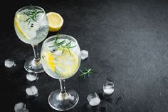 two glasses filled with lemonade and rosemary garnish