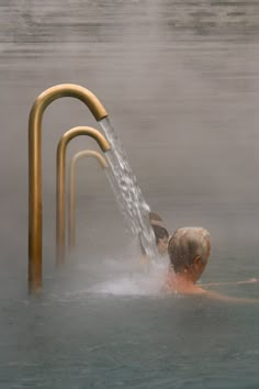 a man swimming in the water with a hose attached to it