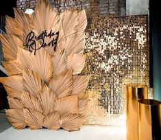 an artistic display in front of a brick wall with gold foiling on the side