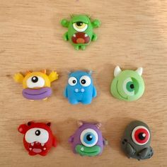 there are many different toy monsters on the table together, including one with an eye