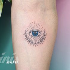 an eye tattoo on the left leg