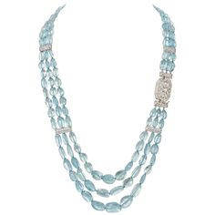 This triple-strand necklace boasts 164 smooth oval Aquamarine weighing 509.35 Carats all hand knotted to lay perfectly. While the necklace carries substance, the smooth oval gemstones lend an organic and soft feel that allows this necklace to be worn with versatility from day to evening seamlessly. The Clasp is also the focal point of this piece. It is a vintage treasure boasting 3.72 Carats of Diamonds set in Platinum. The craftsmanship is impeccable, and it has been cleaned, polished and conve Luxury Double Strand Gemstone Beaded Necklace, Luxury Sapphire Single Strand Necklaces, Jessica Pearson, Glamorous Jewelry, Pearl And Diamond Necklace, Royal Jewels, Modern Necklaces, Aquamarine Gemstone, Multi Strand Necklace