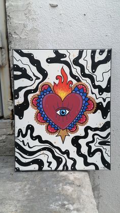 a painting on the side of a building with an evil heart and eye painted on it