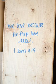 a piece of wood with writing on it that says, we love because he first saw us