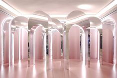 an empty room with pink walls and arches