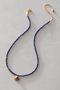 Bring a touch of the sun to any style with this so cool choker featured in a beaded design with starburst pendant of lapis-the stone of power, protection, and healing. * Sun - vitality, leadership, life * Lapis- protection, power, healing * Pendant size - 10 x 10mm * Bead size - 2mm faceted round beads * Necklace length - 14" + 3" extension * 18kt gold plate over brass * Made in the USA | Satya Jewelry Light Seeker Choker at Free People in Blue Hip Jewelry, Starburst Pendant, Homemade Necklaces, Satya Jewelry, Making Necklaces, Round Bead Necklace, Beaded Necklace Designs, Blue Beaded Necklace, Jewelry Making Necklace