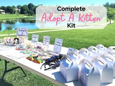 a table that has some bags on it with the words, complete adopt a kitten kit