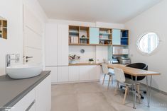 a kitchen with a sink, table and cabinets