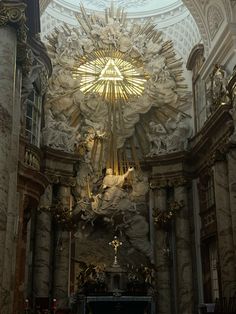 the inside of a church with statues and lights