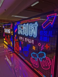 neon signs on the wall in an airport