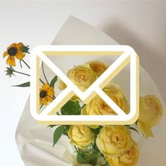 a bouquet of yellow roses sitting on top of a white envelope with the letter x in it