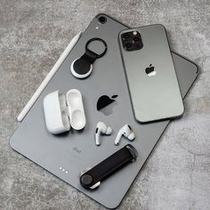 an iphone, earbuds and headphones are sitting on top of a table