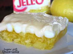 a piece of cake sitting on top of a white plate next to a box of jello