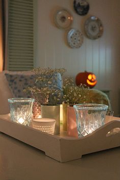 some candles are sitting on a tray in the living room