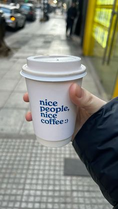 a person holding up a coffee cup with the words nice people, nice coffee on it