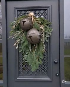 the door is decorated with ornaments and greenery