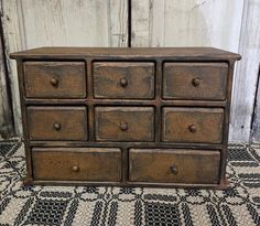 an old wooden dresser sitting on top of a rug