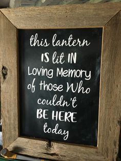 a wooden frame with a chalkboard saying this lantern is lit in loving memory of those who couldn't be here today