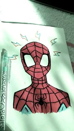 a drawing of a spider - man on paper with marker and crayon pens