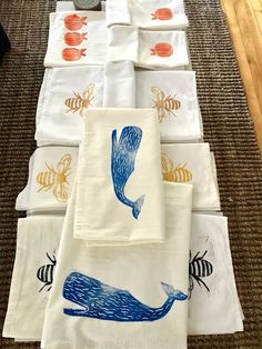 towels are laid out on the floor with different designs