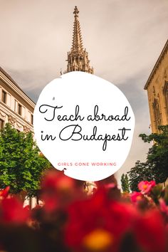 a church tower with the words teach about in buddapet surrounded by red flowers