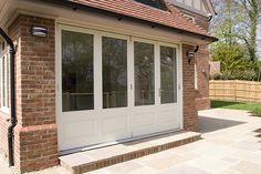 a brick house with double doors and windows