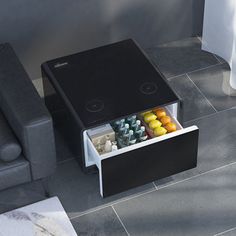 a coffee table with an open drawer on it