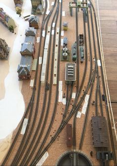 a model train set is shown with many tracks and cars on the ground next to each other