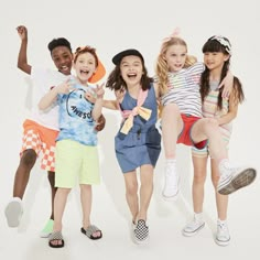 four children jumping in the air with their arms up