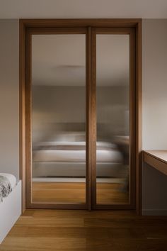 a bedroom with sliding glass doors leading to a bed