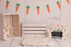 two wooden crates with carrots on them and some bunny figurines next to it