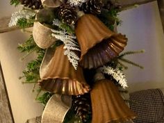 a christmas wreath with bells and pine cones