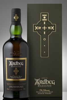 a bottle of ardbog whisky next to a box with a cross on it