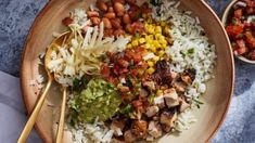 a bowl filled with rice, beans and vegetables