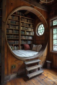 a circular bed in the corner of a room with bookshelves and shelves full of books