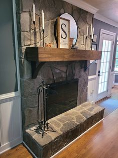 a stone fireplace with candles on the mantle