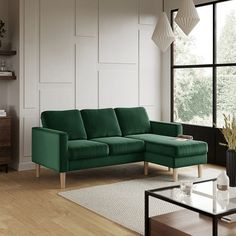 a blue couch sitting in front of a window